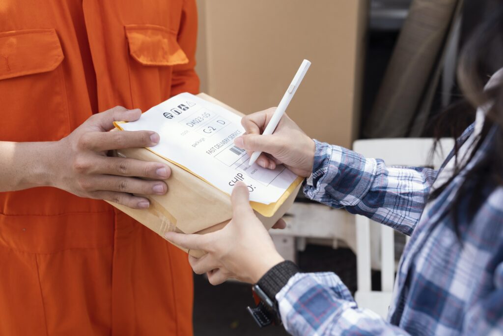 Customer signing for returned parcel during reverse logistics process