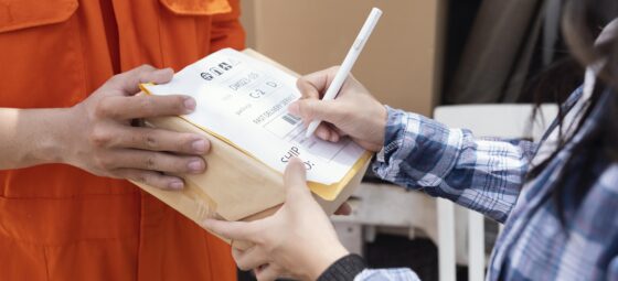 Customer signing for returned parcel during reverse logistics process